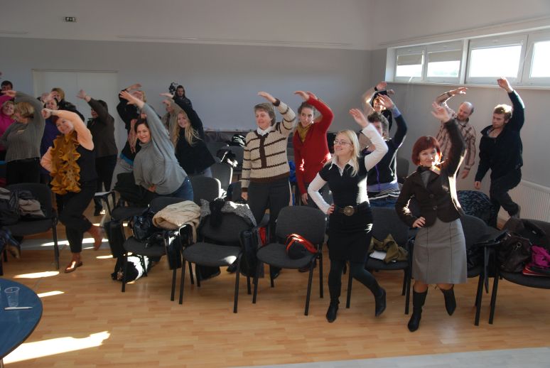 many people doing guestures in a lesson
