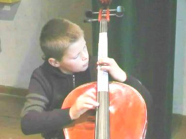 boy placing fingers accurately on cello-fingerboard