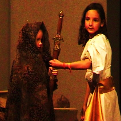 language-theatre little girl giving a sword to a beggar