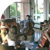 kids sitting in a circle playing cello
